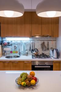 a bowl of fruit on a counter in a kitchen at Hyacinth House in Tbilisi City +31 photos