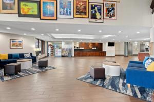 a lobby with two blue couches and tables in a hospital at Comfort Suites Bethlehem Near Lehigh University and LVI Airport in Bethlehem