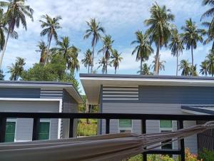 a view from the balcony of a house with palm trees at Stylish 1BR Retreat with Workspace & Hammock in Hinkong