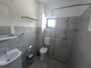 a bathroom with a shower and a toilet and a sink at Vila La Fernando in Tuzla +19 photos