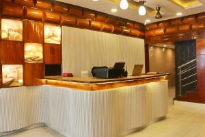 an office with a reception counter with a laptop on it at HOTEL Nh MAJESTIC in Bangalore