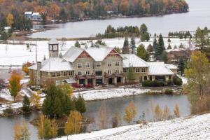 an aerial view of a large house on a lake at Calabogie Peaks Resort, an Ascend Collection Hotel in Calabogie