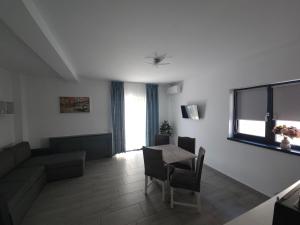 a living room with a table and a couch at Vila La Fernando in Tuzla