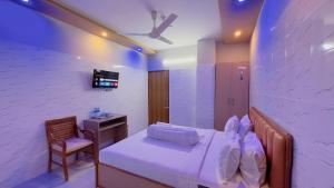 a bedroom with a bed and a chair and a desk at Hotel Sunrise Int in Dhaka