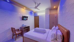 a bedroom with a bed and a chair and a desk at Hotel Sunrise Int in Dhaka