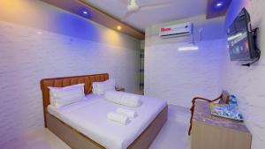 a small bedroom with a bed with towels on it at Hotel Sunrise Int in Dhaka