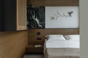 a hotel room with a bed and a picture at IzaVera Luxury Suites - Vera in Heraklio