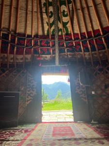 an open door in a building with a view of a mountain at Ak-Suu Eco House in Teploklyuchinskoye