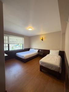 a bedroom with two beds and a window at Bön Valley in Jomsom +19 photos