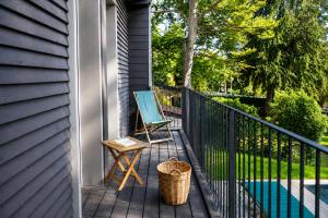 a deck with a chair and a basket on a house at Il Lavatoio in Cissano +25 photos