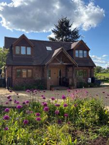 a house with a bunch of flowers in front of it at Private Room - Sleeps 2 - Private Entry - Parking in Solihull