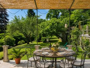 a table and chairs on a patio at Corte Villa Donati in Cissano