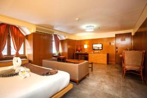 a hotel room with a bed and a desk at Crown Regency Beach Resort in Boracay