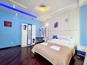 a bedroom with a large bed and blue walls at Вілла з 6 Спальнями Басейн Більярд Сауна BBQ Укриття in Odesa +49 photos