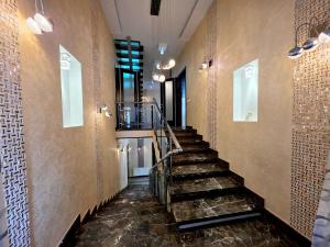 a hallway with a staircase in a building at Вілла з 6 Спальнями Басейн Більярд Сауна BBQ Укриття in Odesa