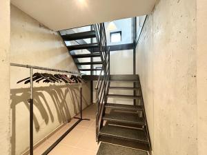 a staircase in a room with a stair case at Paradis d'Ubaye - Terrasse - Plan d'eau - Jardin in Jausiers
