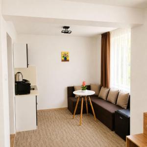 a living room with a couch and a table at Къща за гости КрисиЯна in Zlatograd