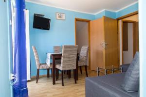 a living room with a dining room table and chairs at Marea in Veli Lošinj