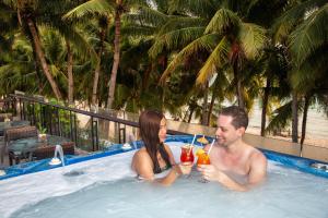 a man and a woman sitting in a hot tub at Crown Regency Beach Resort in Boracay