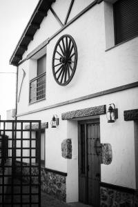 a black and white photo of a building with a wheel at Casa Rural El Pajar de Puchero in Ruidera