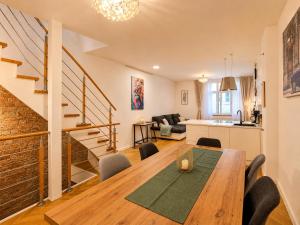 a dining room and living room with a table and chairs at Wismar Apartments - Cozy and Central in Wismar
