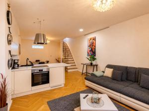 a living room with a couch and a kitchen at Wismar Apartments - Cozy and Central in Wismar +65 photos