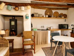 a living room with a table and a kitchen at Old Corner Cottage in McGregor +11 photos