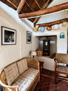 a living room with a couch and a bed at Old Corner Cottage in McGregor