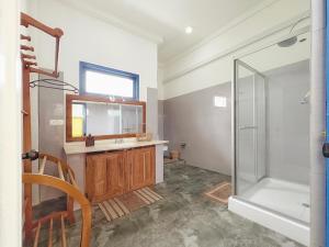 a bathroom with a shower and a sink and a mirror at Phoenix house ahangama in Ahangama +50 photos