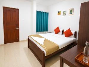 a bedroom with a bed and a blue curtain at Goa Villagio Hideaway in Majorda +19 photos