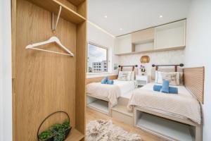 a bedroom with two beds and a window at Mar & Sol Penthouse in Portimão +37 photos