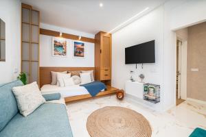 a hotel room with a bed and a tv at Mar & Sol Penthouse in Portimão