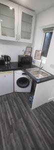 a kitchen with a sink and a washing machine at lovely Studio Flat in The Hyde