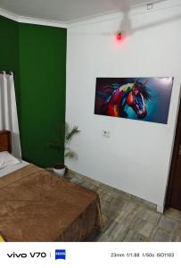 a bedroom with a painting on the wall at Easystayhomestay in Kunnamangalam