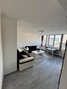 a living room with a couch and a table at Apartman Tuzla in Tuzla