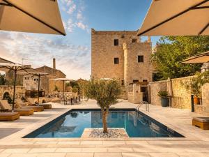 a swimming pool in front of a building at Areos Polis Boutique Hotel in Areopoli