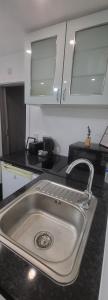a kitchen counter with a sink in a kitchen at lovely Studio Flat in The Hyde
