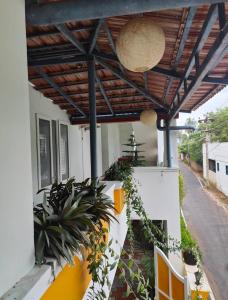 a patio with awning and plants on a building at Serenity Sunrise Beach Resort in Pondicherry