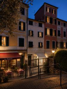 a building with tables and chairs in front of it at Maison Cecilia in Rapallo