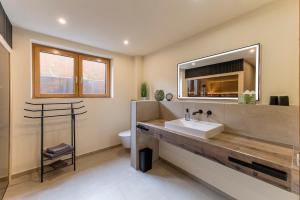 a bathroom with a sink and a mirror at Auszeitquartier in Biedenkopf +16 photos