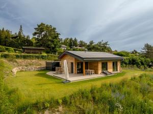 a log home with a patio and a yard at Auszeitquartier in Biedenkopf