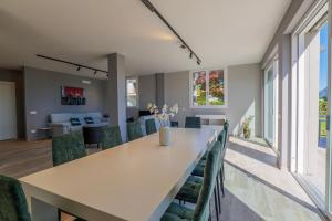 a dining room with a long table and chairs at Villa Spa Nipotine Casa Sorelle in Cissano +28 photos