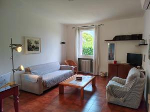 a living room with a couch and a table at Civico 21-FreeParking in Vescovato