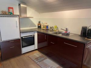 a kitchen with a sink and a stove top oven at Ferienwohnung in Mörel in Mörel