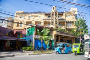 a blue vehicle parked in front of a building at Crown Regency Prince Resort in Boracay