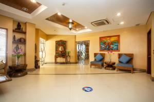 a lobby with two chairs and a painting on the wall at Crown Regency Prince Resort in Boracay