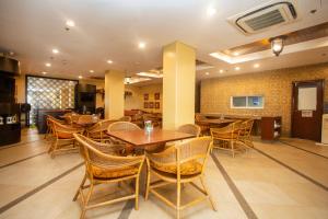a dining room with wooden tables and chairs at Crown Regency Prince Resort in Boracay