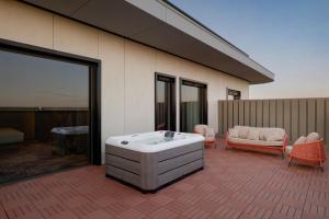 a jacuzzi tub sitting on the side of a building at Mercure Oradea in Oradea