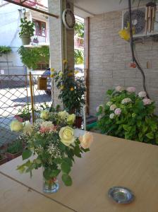 a vase filled with flowers sitting on a table at Casa Petre in Eforie Nord