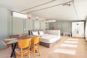 a bedroom with a bed and a table and chairs at Marine Point Hotel & Antalya in Antalya +33 photos